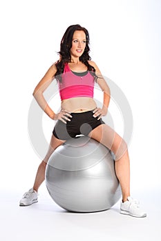 Beautiful woman fitness routine using gym ball