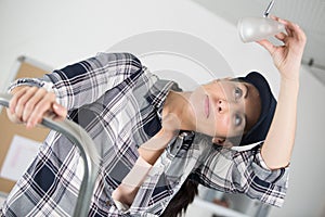 beautiful woman fixing light