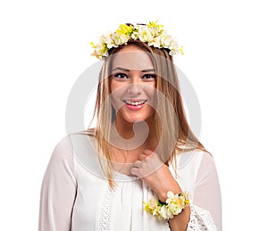 Beautiful woman with a flower garland and a white dress