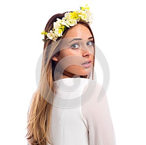 Beautiful woman with a flower garland and a white dress