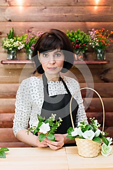 Beautiful woman, flower shop clerk behind counter