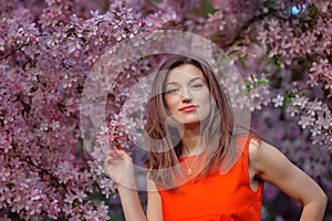 Beautiful woman in the flowering spring garden