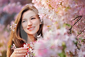 Beautiful woman in the flowering spring garden