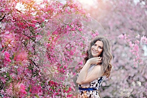 Beautiful woman in the flowering spring garden