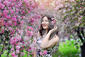 Beautiful woman in the flowering spring garden