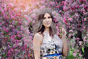 Beautiful woman in the flowering spring garden