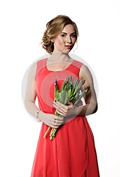 Beautiful woman with flowers tulips on a light background