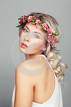 Beautiful Woman with Flowers Wreath. Blonde Curly Hair