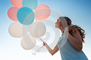 beautiful woman with flying multicolored balloons