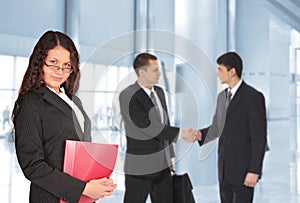 Beautiful woman with folder and businessmen
