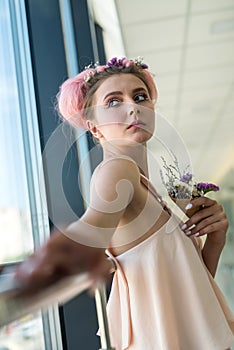 Beautiful woman with fresh makeup posing near window