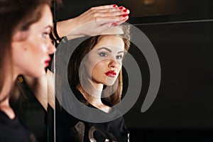 Beautiful woman in front of mirror bw