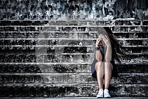 Beautiful woman in frustrated depression sitting on the stairs,