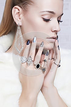 Beautiful woman in fur, hands with jewelry.girl with make-up and manicure