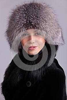 Beautiful woman in a fur hat and coat