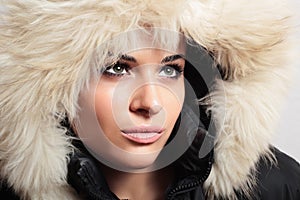 Beautiful woman with fur. white fur hood. winter style. make-up. fashion beauty girl.