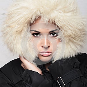 Beautiful woman with fur. white hood. winter style.make-up