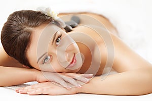 Beautiful Woman Getting Hot Stone Massage in Spa Salon. Beauty t