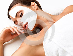 Beautiful Woman Getting Spa Treatment. Cosmetic Mask on Face. Sk