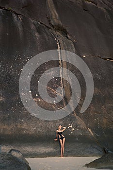 Beautiful woman among the giant rocks