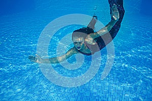 Beautiful woman girl dress underwater diving swim blue sunny day pool