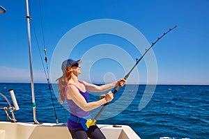 Beautiful woman girl fishing rod trolling in boat