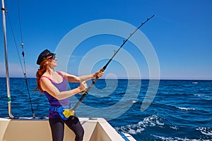 Beautiful woman girl fishing rod trolling in boat