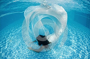 Beautiful woman girl white dress underwater diving swim blue sunny day pool