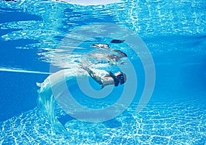 Beautiful woman girl white dress underwater diving swim blue sunny day pool