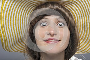 Beautiful woman/girl with yellow hat making faces