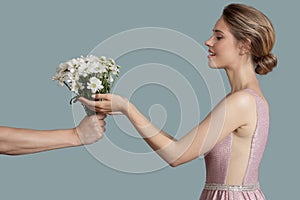 Beautiful woman give chamomile flowers