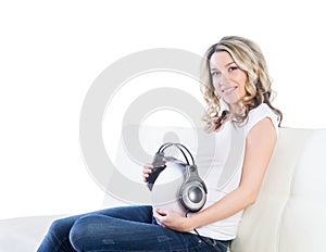 Beautiful woman giving her baby to listen to the music