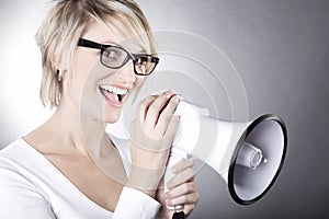 Beautiful woman with glasses and megaphone