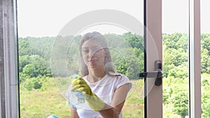 Beautiful woman, in gloves, Cleaning, washing Windows by special sponge