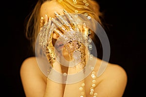 Beautiful woman in gold, golden hands, glitter sensual glamour luxury