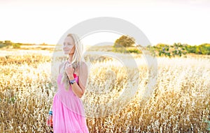 A beautiful woman in golden hay field