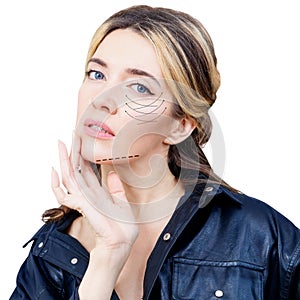 Beautiful woman with graphic lines shows facial lifting effect.