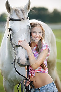 Beautiful woman with gray horse