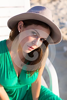 Beautiful woman in a green gown on the beach