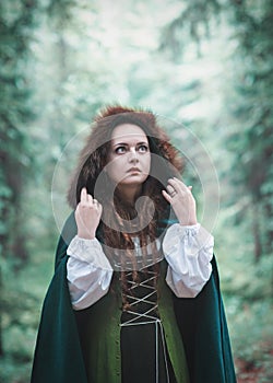 Beautiful woman in green medieval dress outdoor