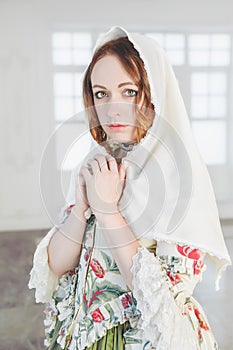 Beautiful woman in green medieval dress with shawl