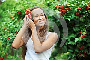 Beautiful woman with guelder rose in hair photo