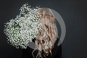 Beautiful woman hairstyle and back with white flowers on black background