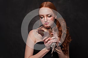 Beautiful woman with Halloween makeup on black background. Studio portrait