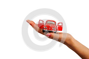 beautiful woman hand holding a red nostalgic toy car