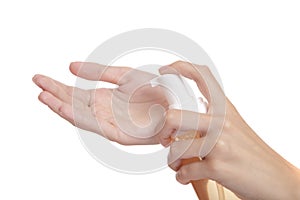 Beautiful woman hand on a white background presses on a bottle of spa cleansing foam. isolate