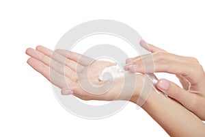 Beautiful woman hand on a white background presses on a bottle of spa cleansing foam. isolate