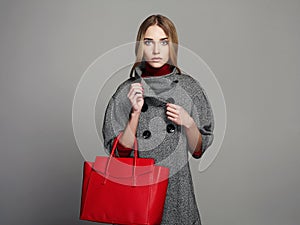 Beautiful Woman with Handbag. Beauty Fashion Girl in topcoat. winter Shopping