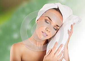 Beautiful woman handle towel in spa salon, after bath