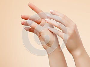Beautiful Woman Hands. Female Hands Applying Cream, Lotion. Spa and Manicure concept. Female hands with french manicure. Soft skin